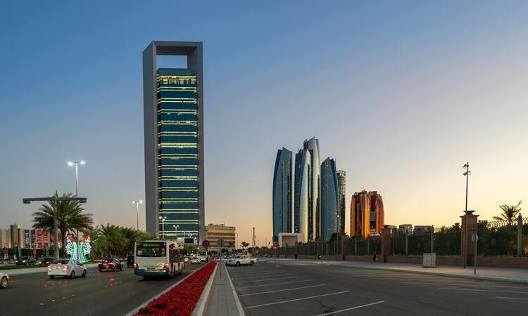 Stunning view of Abu Dhabi's skyline with skyscrapers and traffic at sunset.